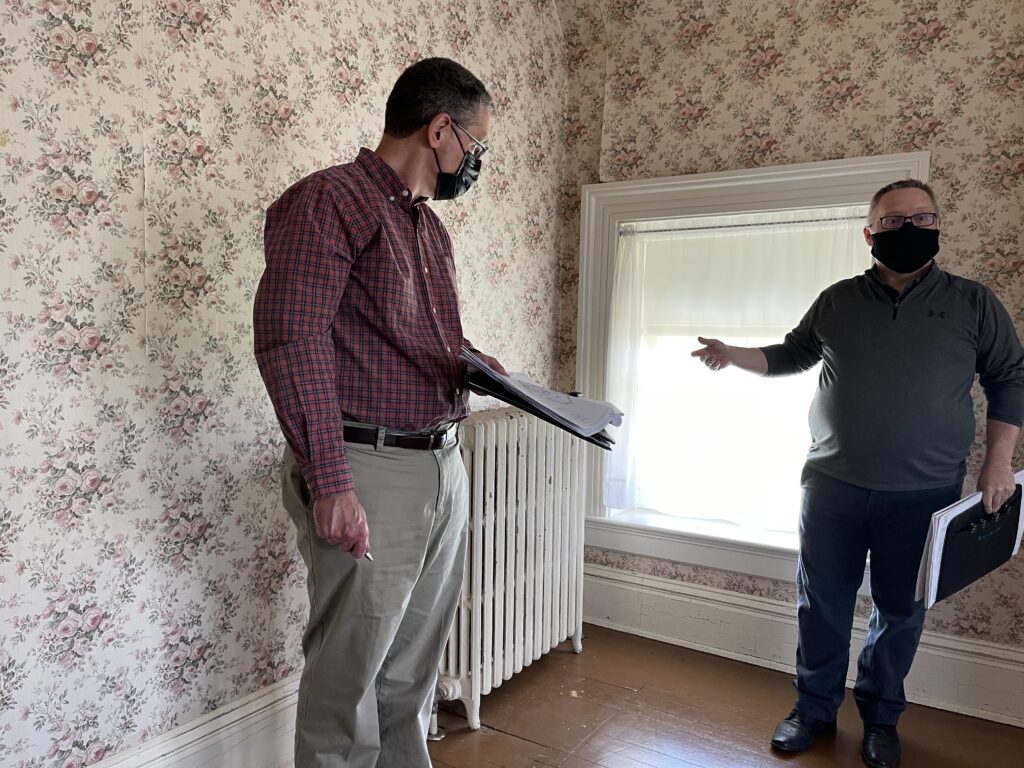 The project team discusses the pre-existing radiators in the former servants' bedroom.